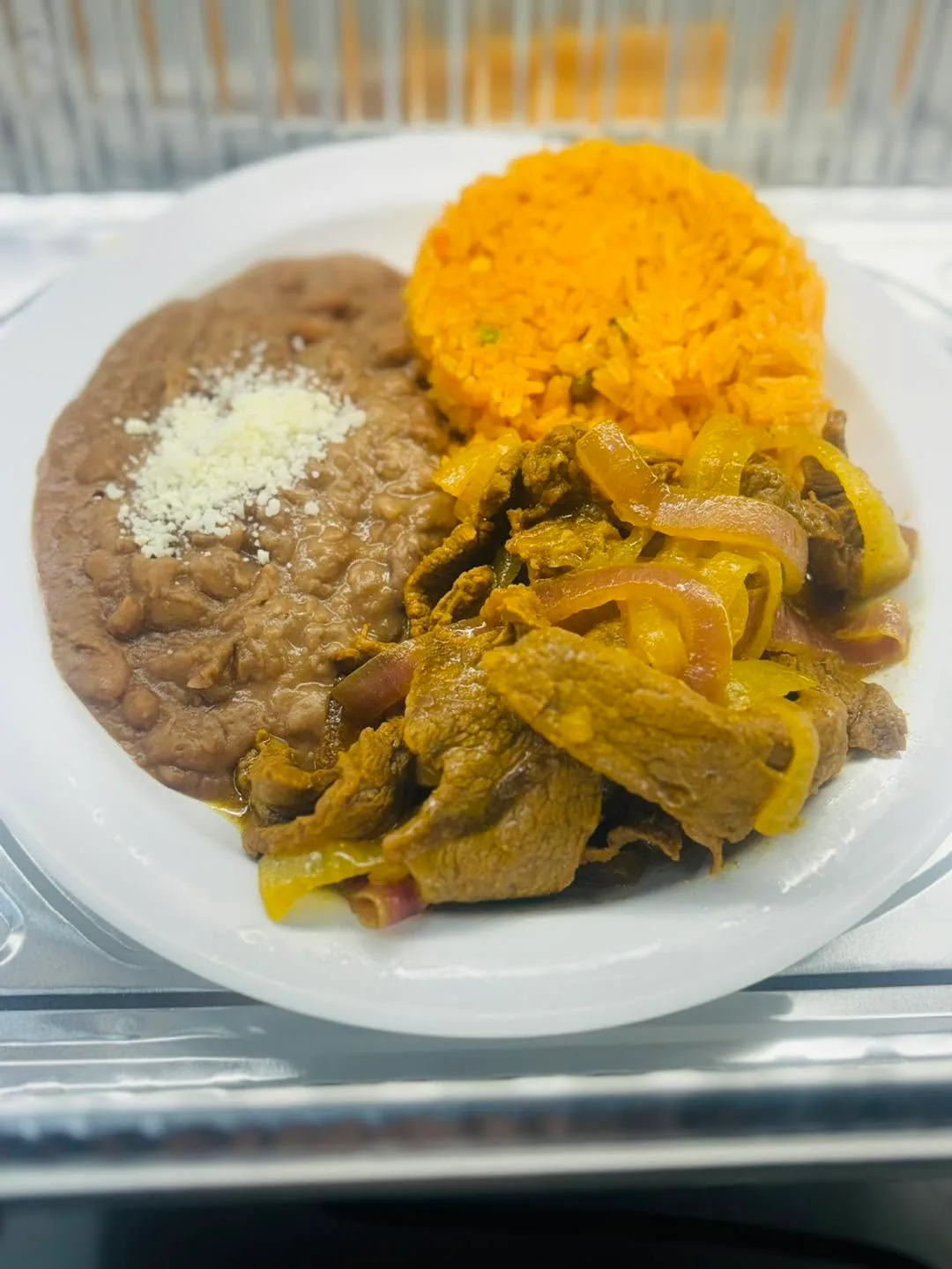 Beef with onions, rice and beans served at Carniceria Camargo