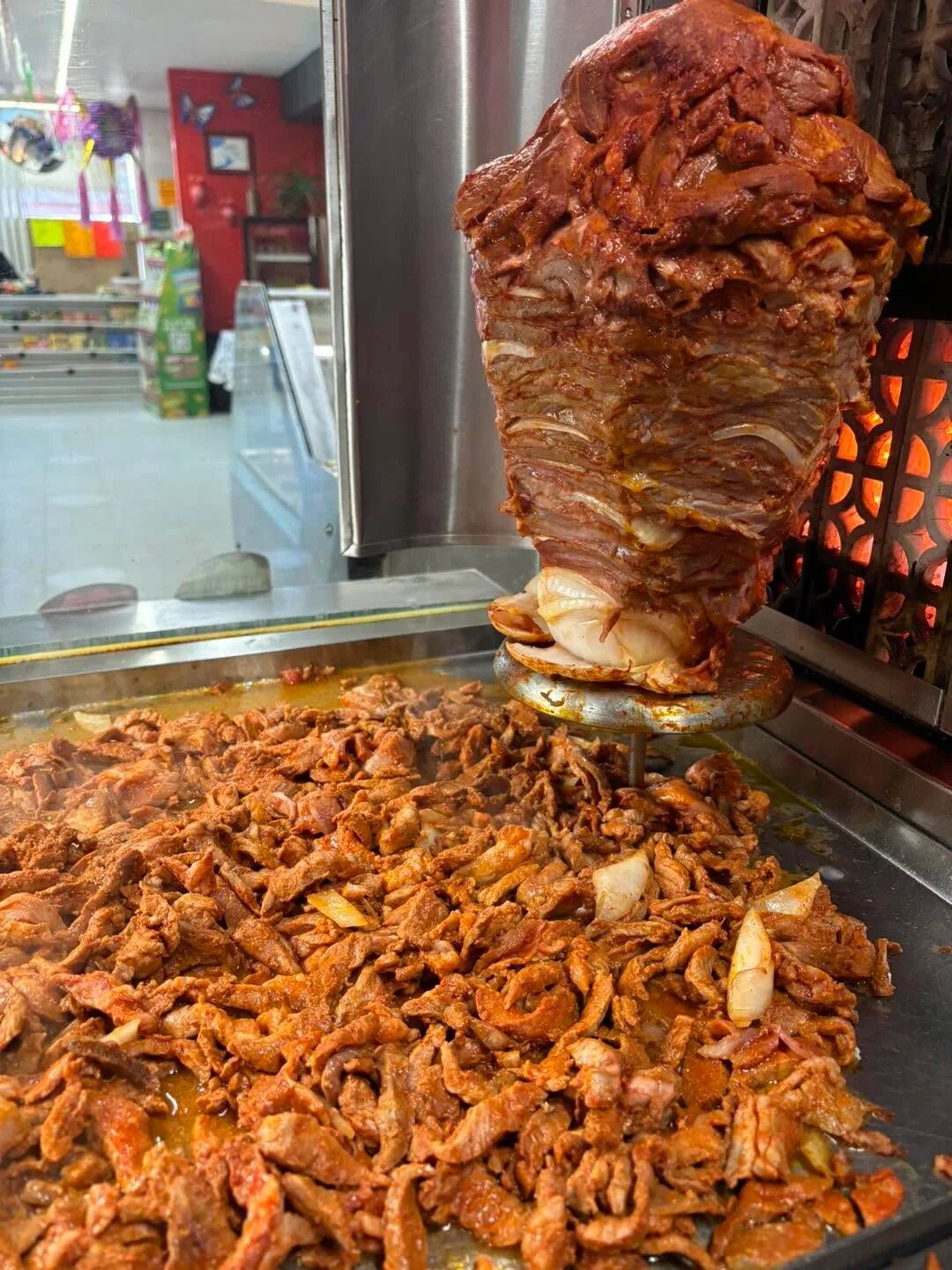 Al pastor being prepared on the trompo at Carniceria Camargo