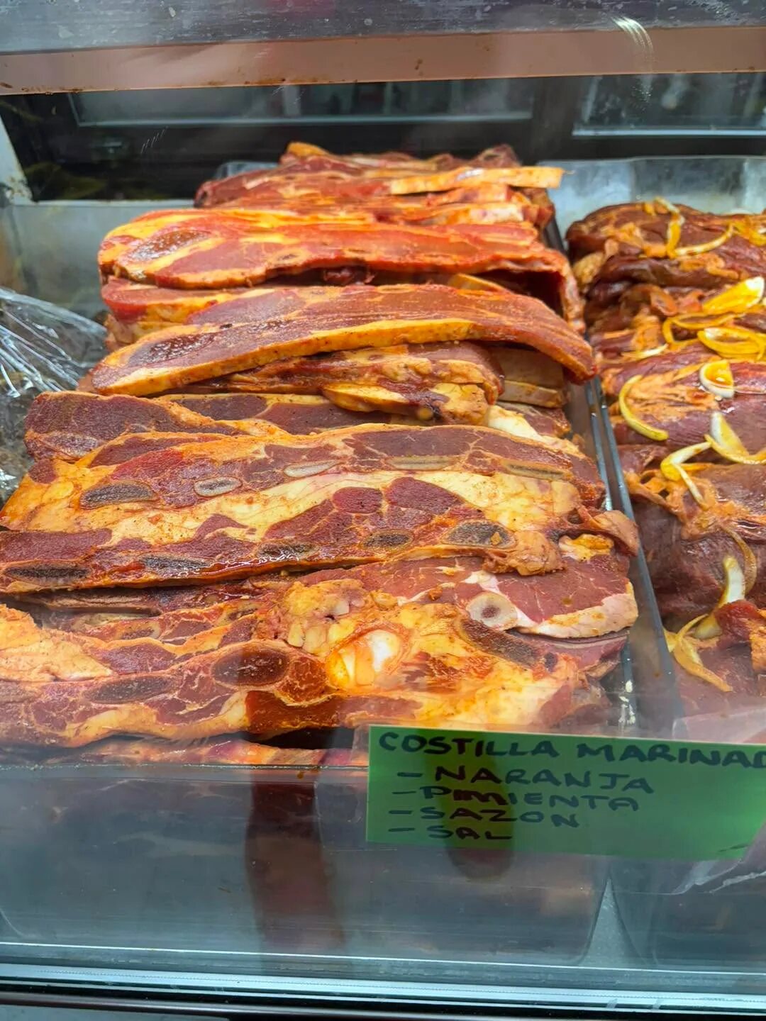 Marinated ribs and seasoned meat selections ready for cooking