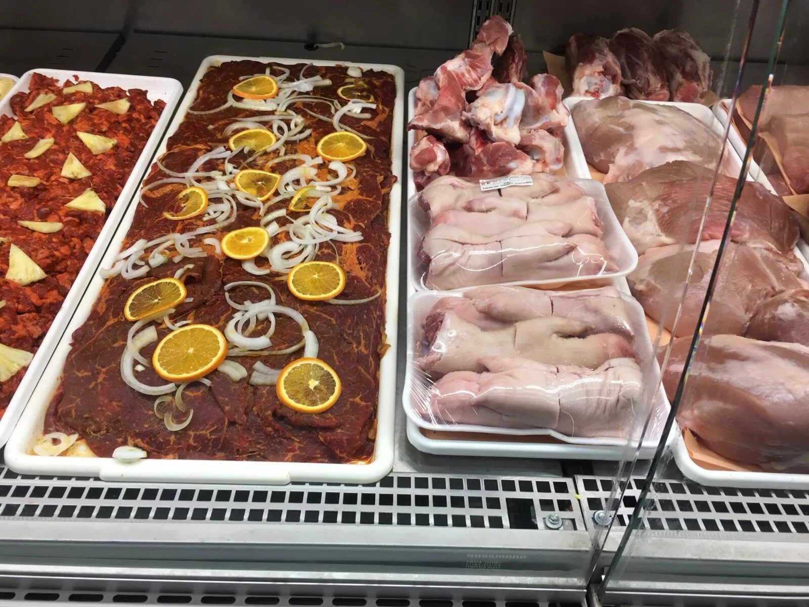 Fresh and marinated butcher selections ready for cooking at Carniceria Camargo