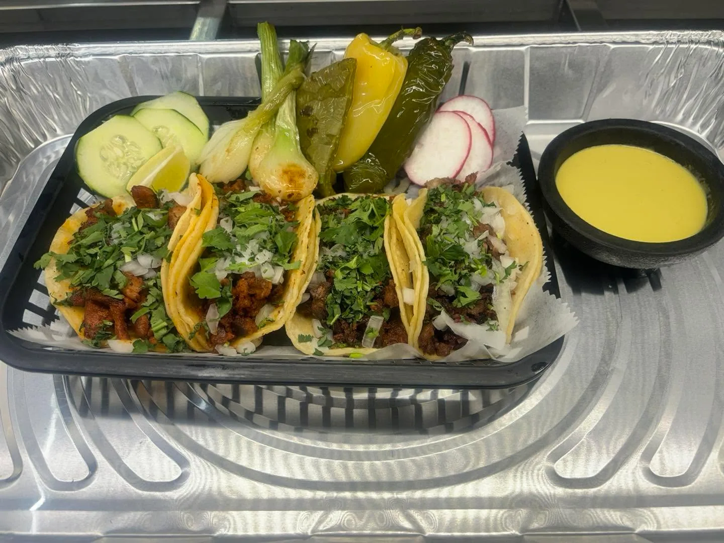 Fresh tacos with cilantro, onion, grilled peppers and lime from Carniceria Camargo